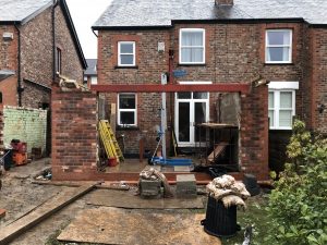 In Bramhall. Single Storey Brick Built Rear Extension with Vaulted Roof, Velux Windows. 3 Pane Aluminium Bi Folding Doors and Glazed Apex